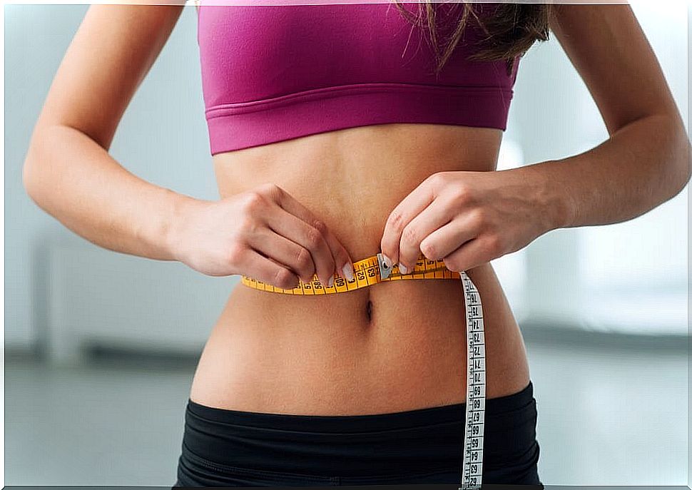 Woman measuring waist circumference