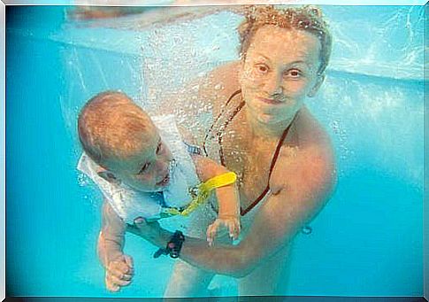 Mother with baby in the pool