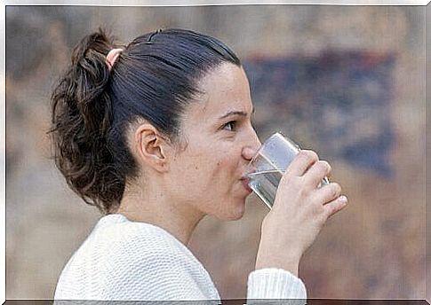 The woman is drinking water