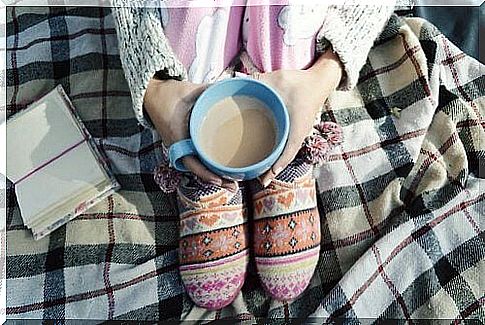 A cup of cocoa in your hands for a healthy sleep